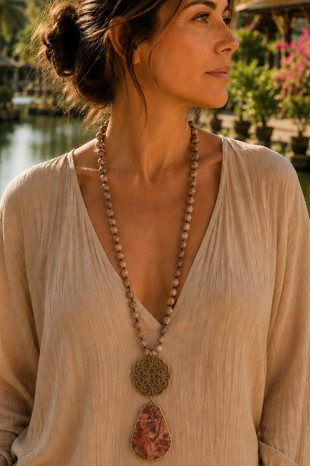 Collar Hippie Chic largo de piedras naturales anudadas en tonos rojos, rosas, blancos y marron, con colgante en los tonos y precioso mandala envejecido.