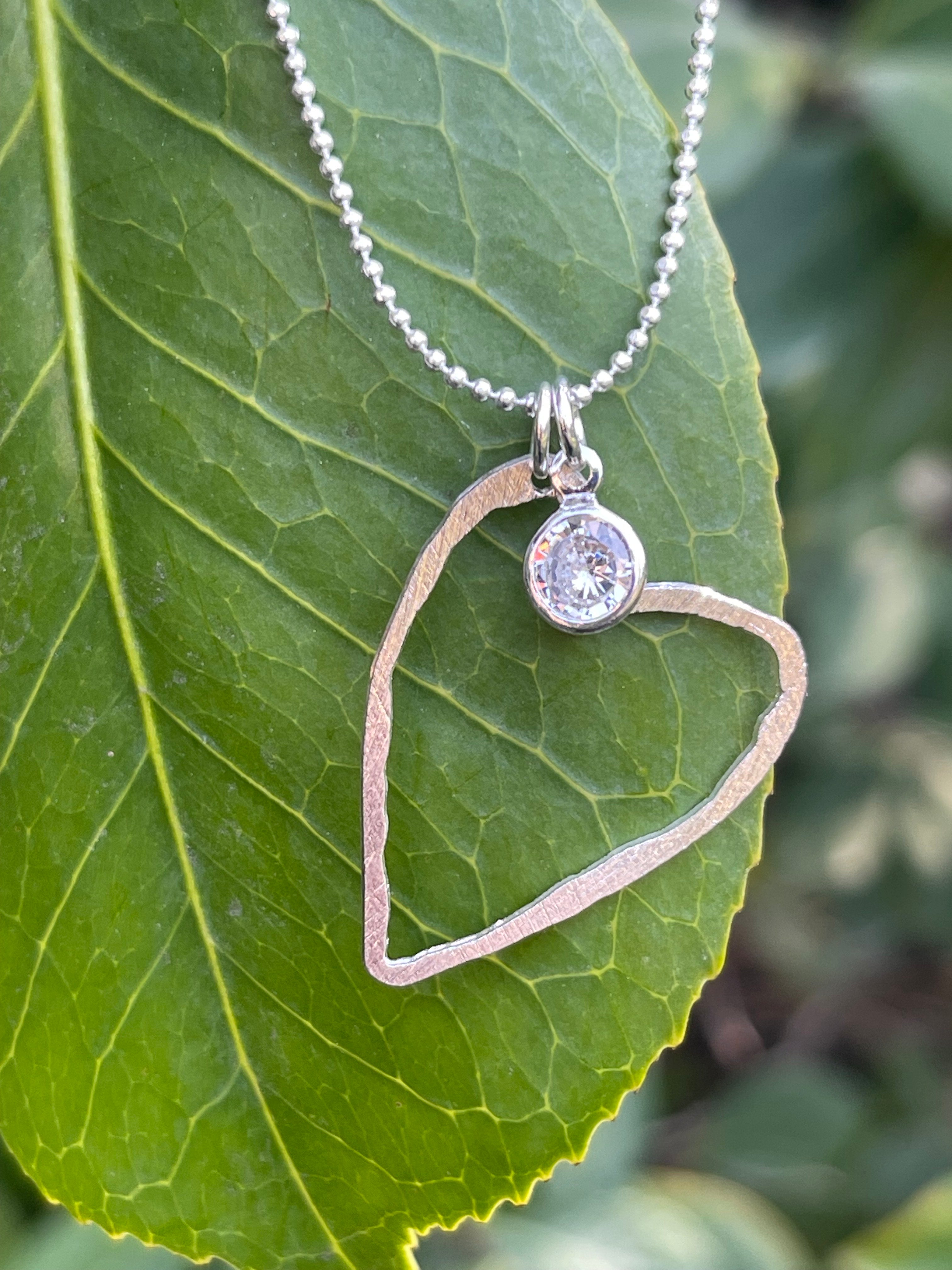 Collar Hippie Chic corto bañado en plata con delicado corazon y punto de luz.