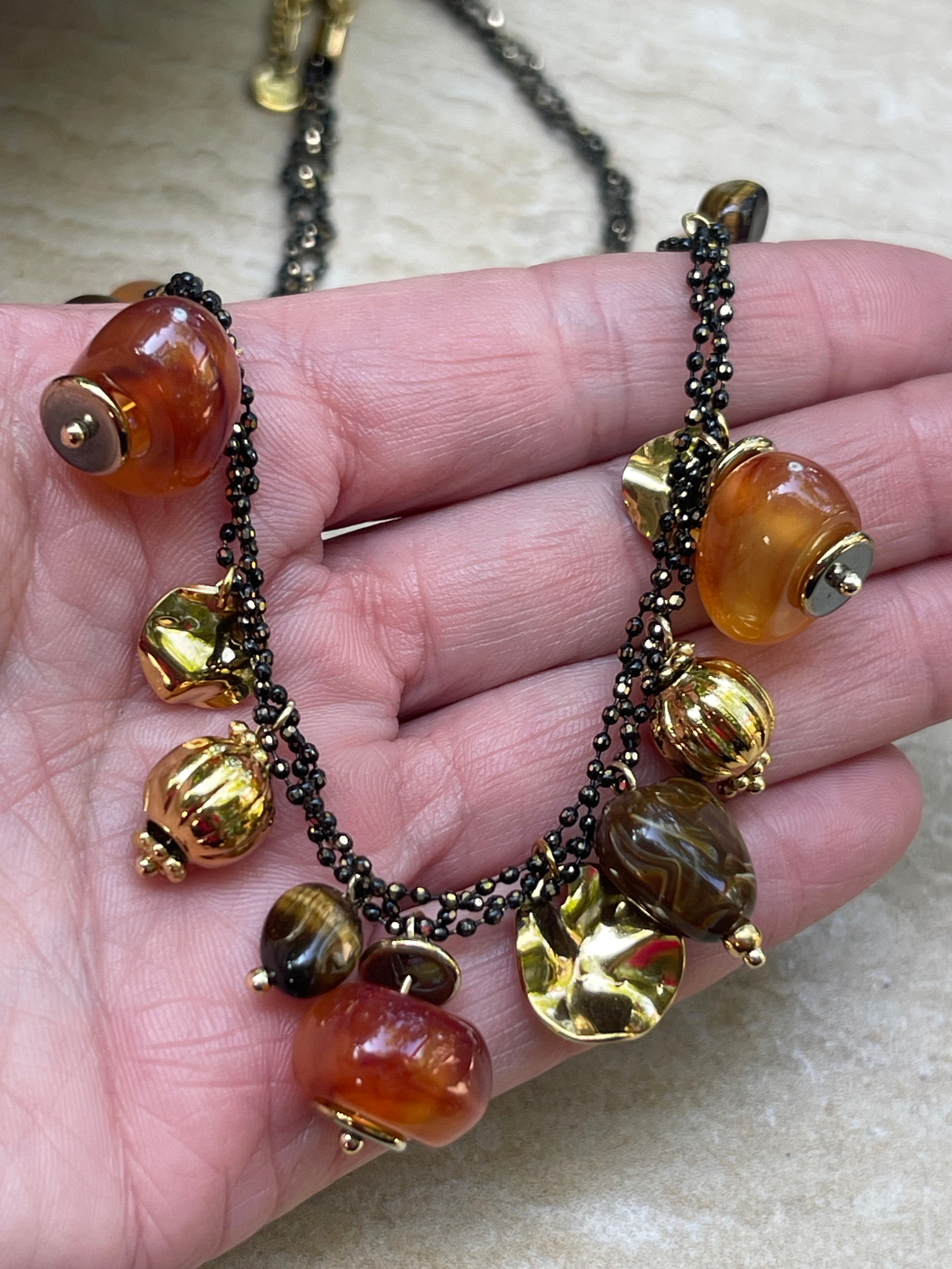 Collar Hippie Chic corto de acero inoxidable dorado, preciosos colgantes en acrilico color caramelo y mostacillas en el contorno.