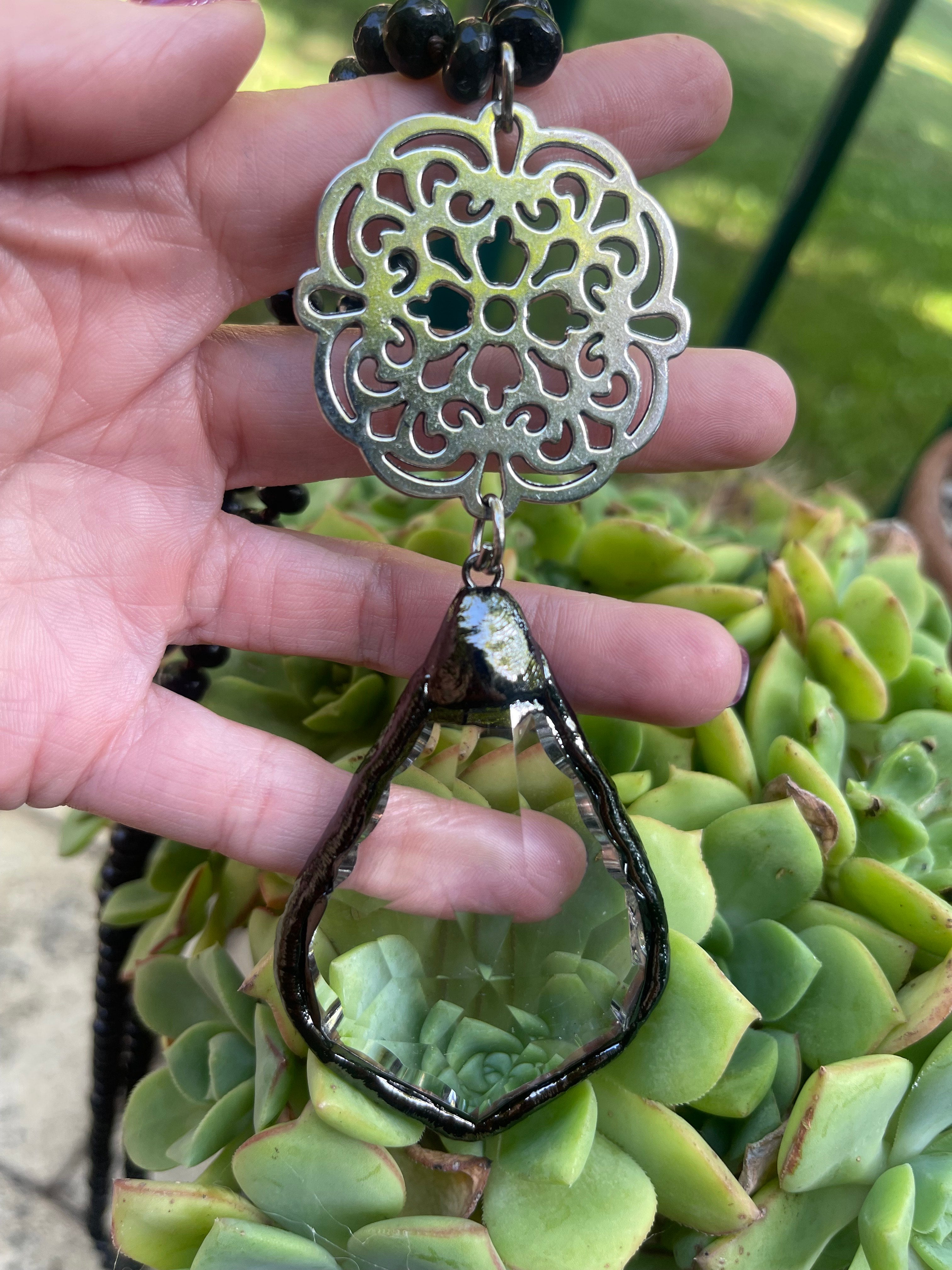 Collar Hippie Chic largo de elegantes piedras naturales negras abacos anudadas y colgante de cristal facetado y base plateada.